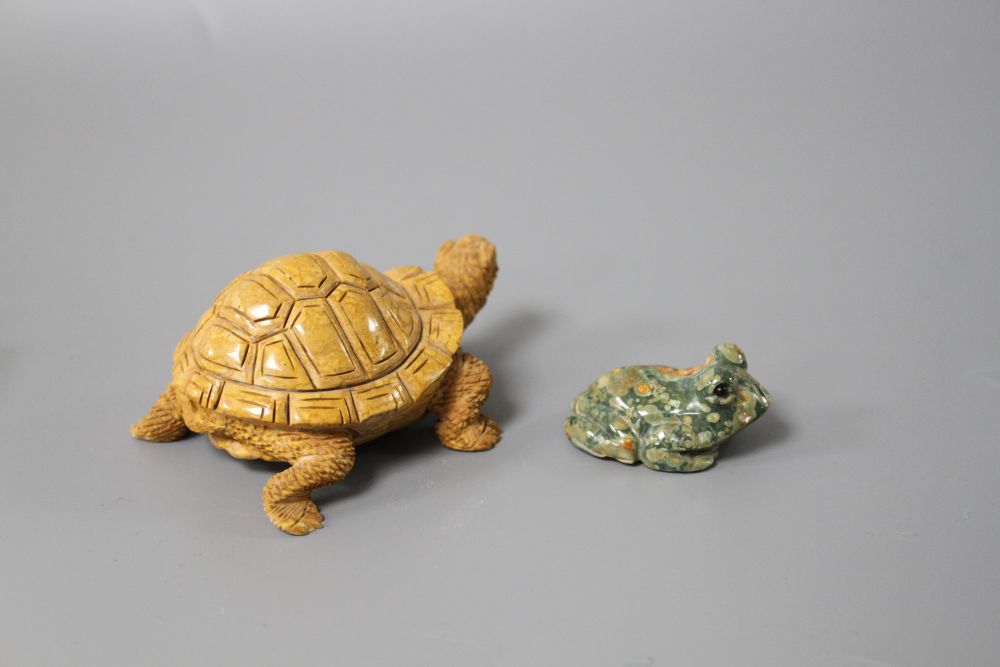 A carved fossil stone tortoise, 8cm and a carved Rhiolite carving of a frog, 4cm